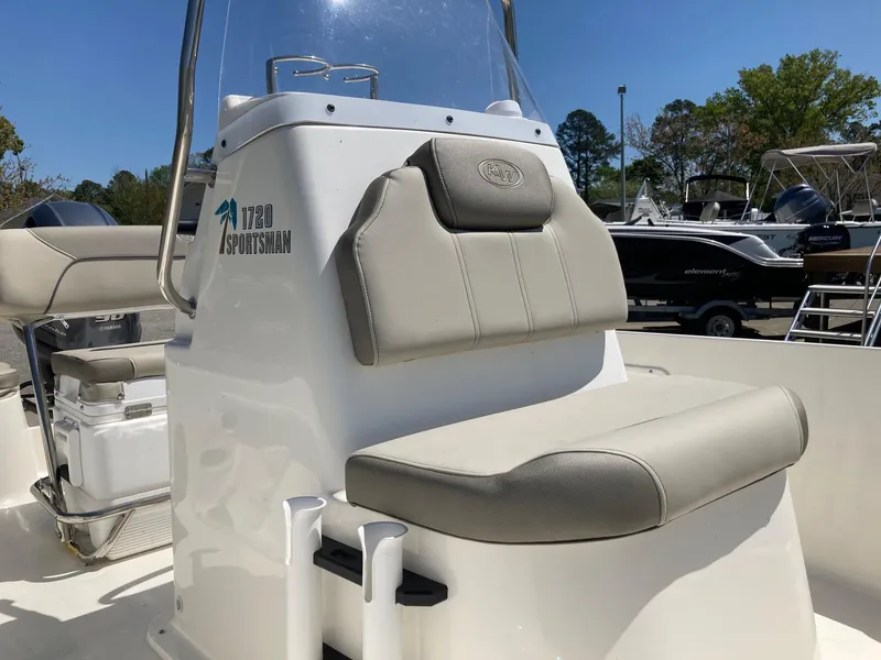 Slide: The Image of 2024 Key West 1720 Sportsman boat interior with cushioned seating and console. - 11