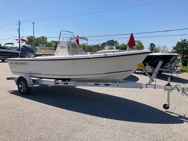 Slide: The Image of 2024 Key West 1720 Sportsman boat on a trailer in a parking lot. - 4