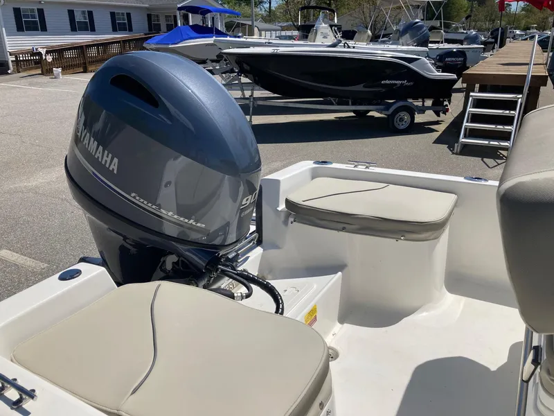 Slide: The Image of 2024 Key West 1720 Sportsman boat with Yamaha outboard motor in a marina. - 11