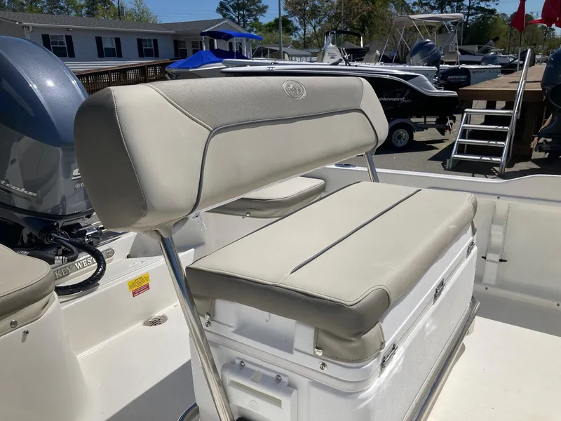 Slide: The Image of 2024 Key West 1720 Sportsman boat with cushioned seating and outboard motor. - 12