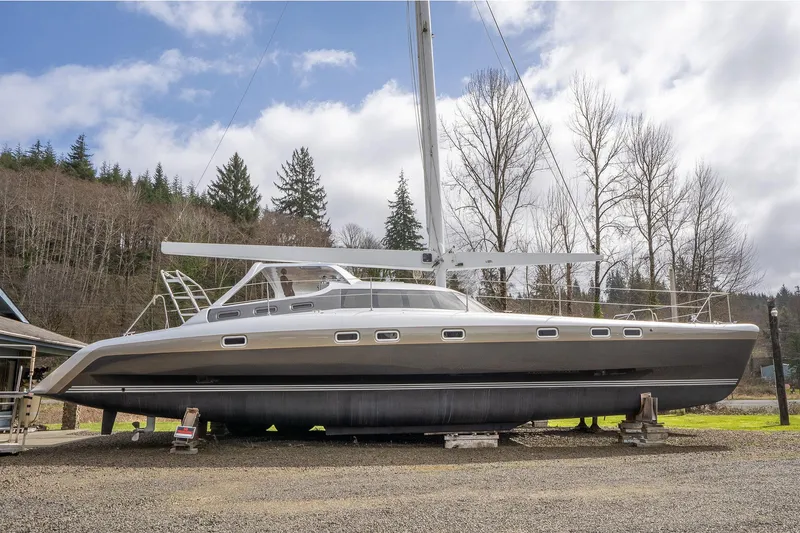 The Image of Shuttleworth 52 AeroRig 2025 yacht on land, surrounded by trees and cloudy sky. - 0