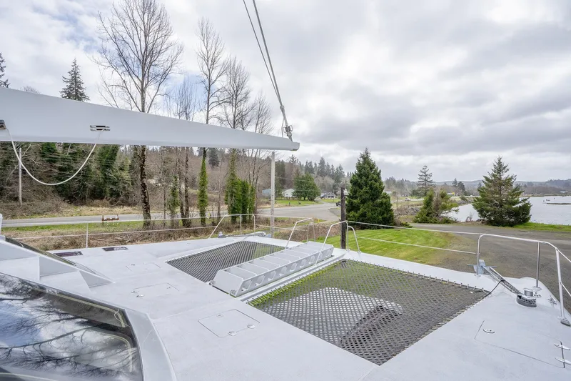 Slide: The Image of 2025 Shuttleworth 52 AeroRig yacht deck with scenic forest and lake view. - 10