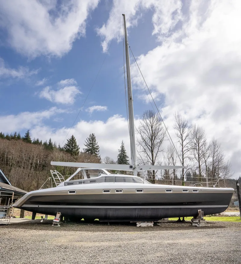 Slide: The Image of 2025 Shuttleworth 52 AeroRig sailboat on land under a cloudy sky. - 2