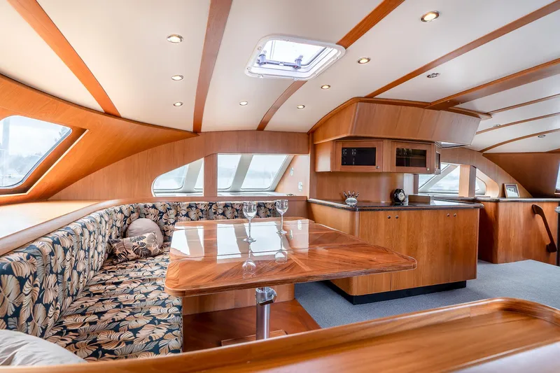 Slide: The Image of Luxurious interior of 2025 Shuttleworth 52 AeroRig yacht with elegant wood finish and seating area. - 23