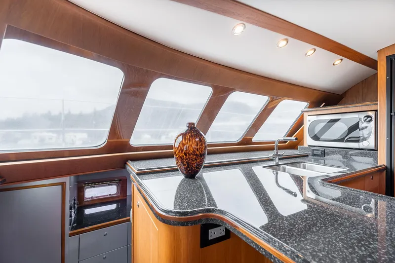 Slide: The Image of Luxurious interior of 2025 Shuttleworth 52 AeroRig yacht with sleek kitchen design. - 29