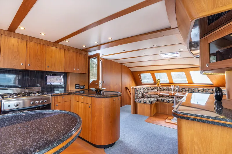 Slide: The Image of Luxurious interior of 2025 Shuttleworth 52 AeroRig yacht with modern kitchen and dining area. - 30