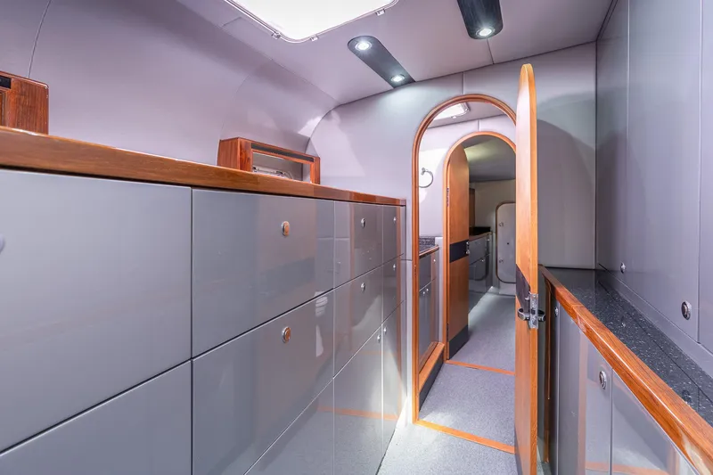 Slide: The Image of Interior of 2025 Shuttleworth 52 AeroRig yacht, featuring sleek cabinetry and modern design. - 31