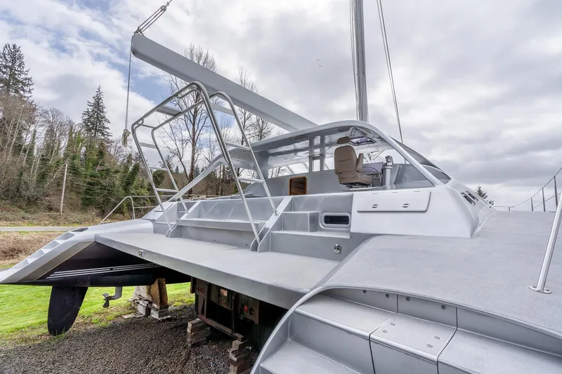 Slide: The Image of 2025 Shuttleworth 52 AeroRig yacht with sleek design, docked outdoors under cloudy sky. - 7