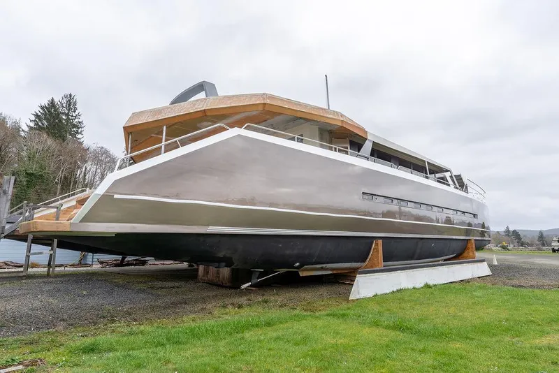 Slide: The Image of 2025 Catamaran Bloomfield 86 Motorsailor on land, sleek design, modern finish. - 2