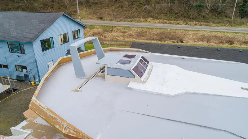 Slide: The Image of 2025 Catamaran Bloomfield 86 Motorsailor under construction near a blue house. - 26