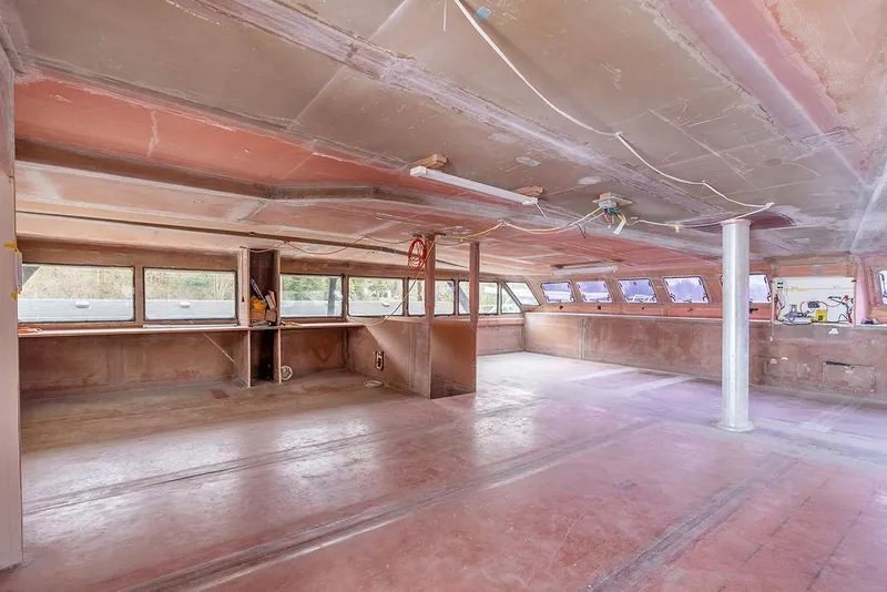 Slide: The Image of Interior of 2025 Catamaran Bloomfield 86 Motorsailor under construction, spacious and unfinished. - 36