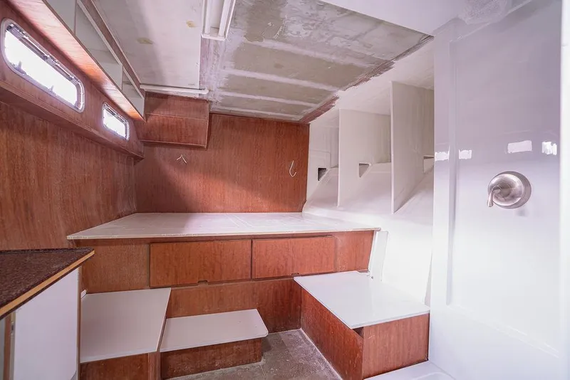 Slide: The Image of Interior of 2025 Catamaran Bloomfield 86 Motorsailor with wooden cabinetry and modern design. - 48