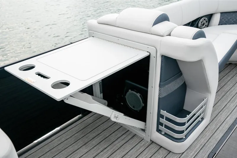 Slide: The Image of 2022 Harris Grand Mariner 250 boat interior with fold-out table and cup holders. - 10