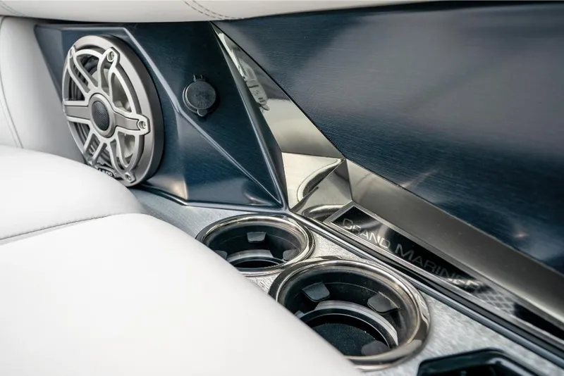 Slide: The Image of Close-up of 2022 Harris Grand Mariner 250 boat interior, featuring cup holders and speaker. - 18