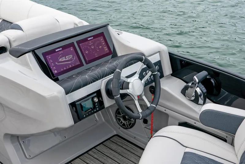 Slide: The Image of 2022 Harris Grand Mariner 250 boat dashboard with dual screens and steering wheel. - 19