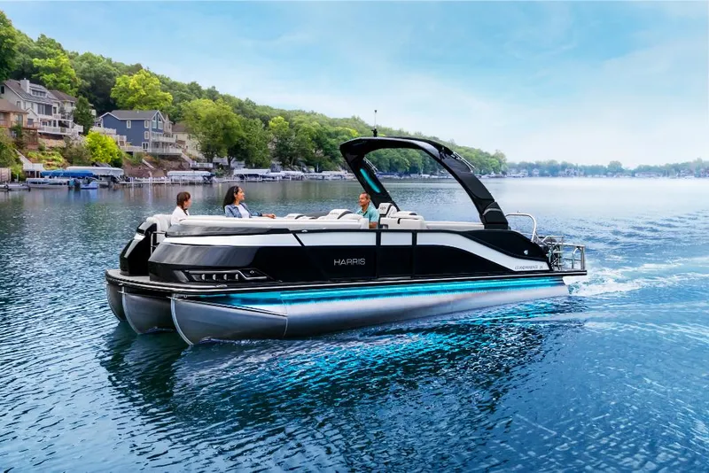 Slide: The Image of 2022 Harris Grand Mariner 250 pontoon boat cruising on a scenic lake. - 30