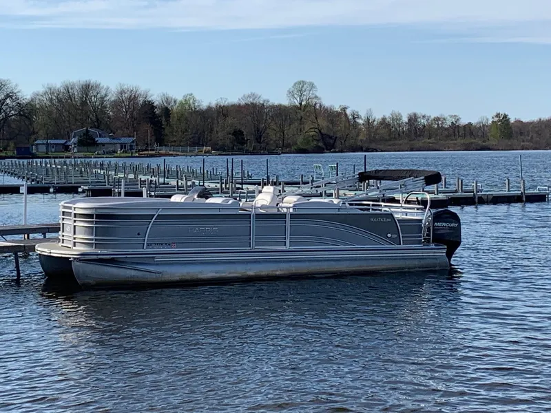 Slide: The Image of 2014 Harris Solstice 240 pontoon boat docked on a calm lake. - 1