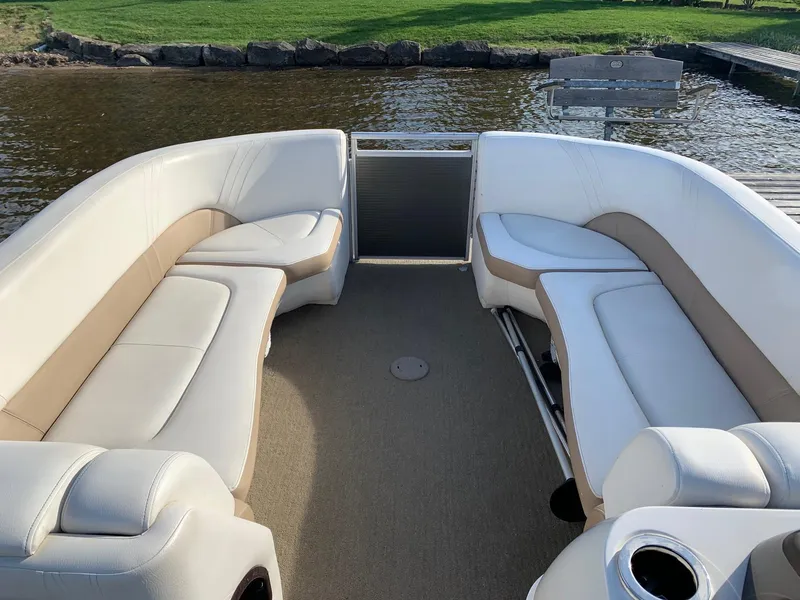 Slide: The Image of 2014 Harris Solstice 240 pontoon boat interior with white and beige seating. - 3
