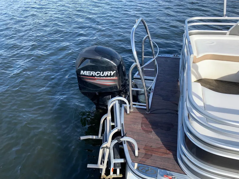 Slide: The Image of 2014 Harris Solstice 240 boat with Mercury outboard motor on water. - 9