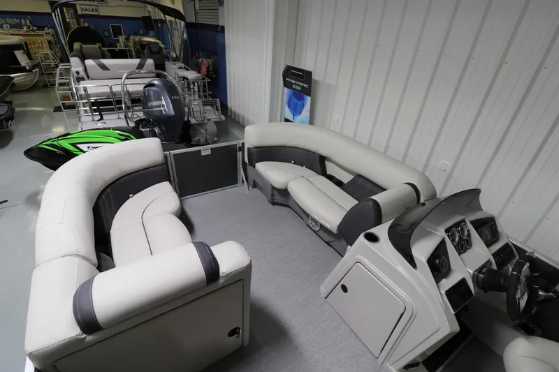 Slide: The Image of 2023 Sylvan Mirage 8522 LZ pontoon boat interior with plush seating and modern dashboard. - 3
