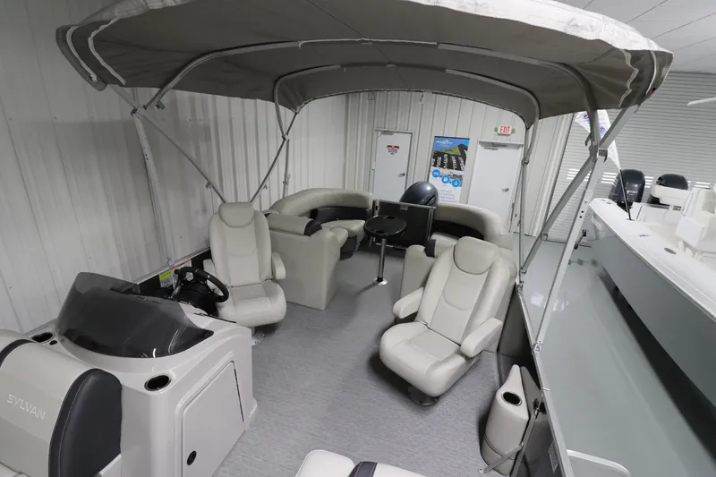 Slide: The Image of 2023 Sylvan Mirage 8522 LZ pontoon boat interior with seating and canopy. - 4