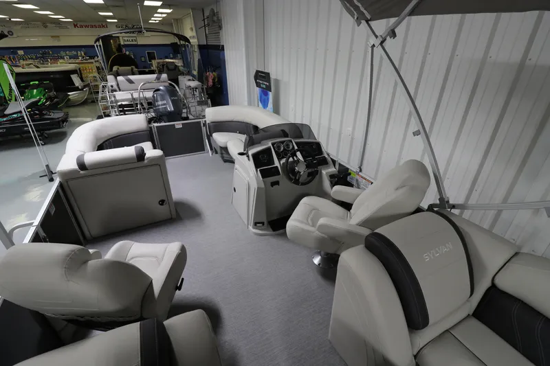 Slide: The Image of 2023 Sylvan Mirage 8522 LZ pontoon boat interior with plush seating and modern helm. - 5