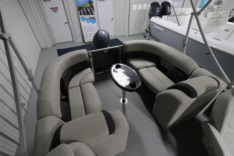 Slide: The Image of 2023 Sylvan Mirage 8522 LZ pontoon boat interior with plush seating and a central table. - 7