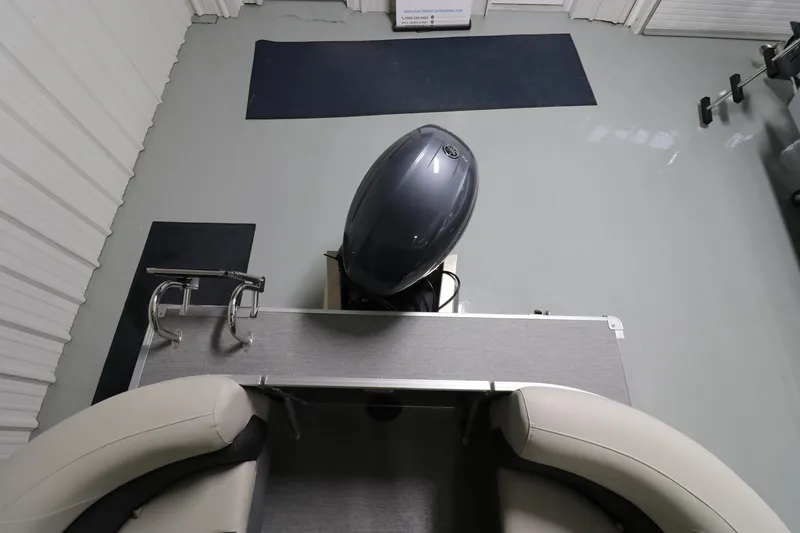 Slide: The Image of 2023 Sylvan Mirage 8522 LZ boat interior with motor, viewed from above. - 8