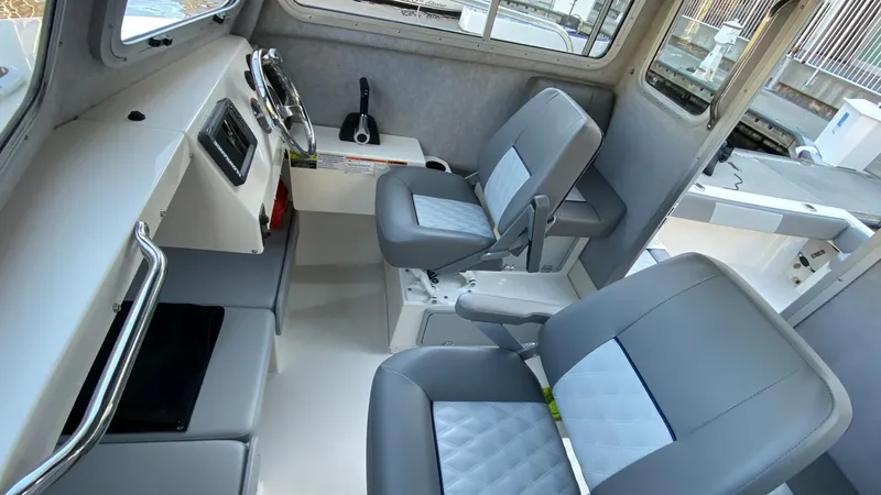 Slide: The Image of 2024 Defiance 220 Admiral EX boat interior with modern seating and control panel. - 8