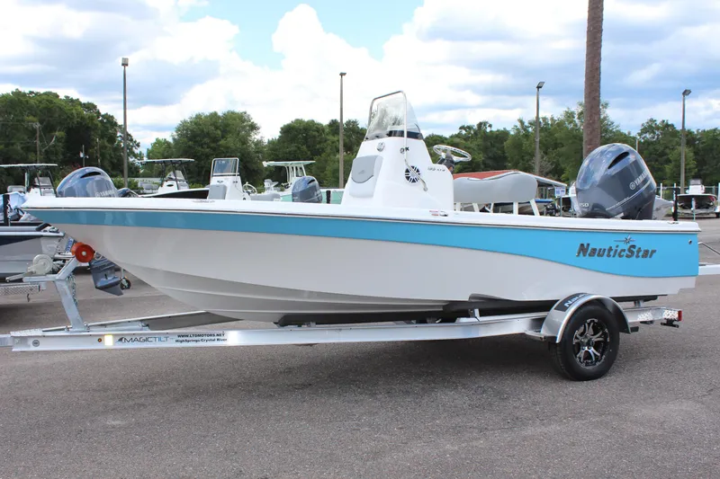 The Image of 2022 NauticStar 195 XTS boat on a trailer in a parking lot. - 1