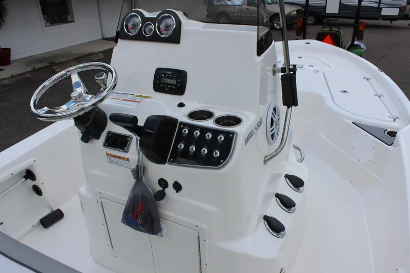 Slide: The Image of 2022 NauticStar 195 XTS boat console with steering wheel and control panel. - 10