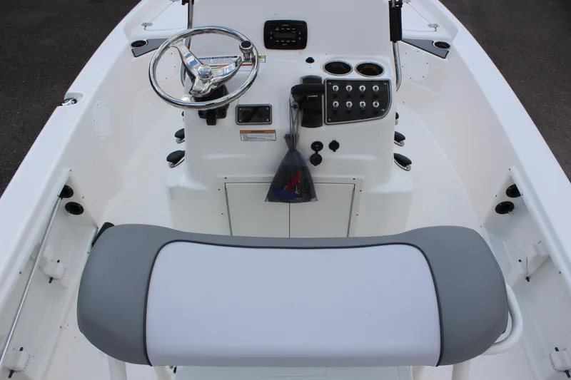 Slide: The Image of 2022 NauticStar 195 XTS boat console with steering wheel and seating. - 12