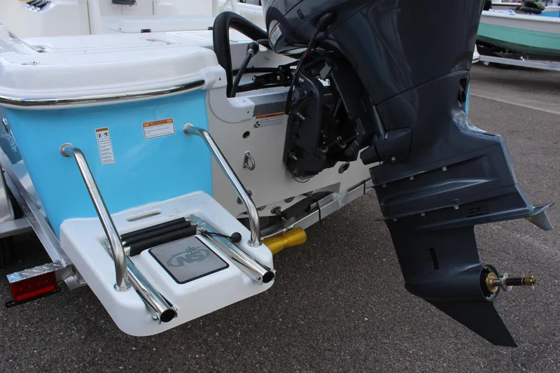 Slide: The Image of 2022 NauticStar 195 XTS boat stern with outboard motor and swim ladder. - 4