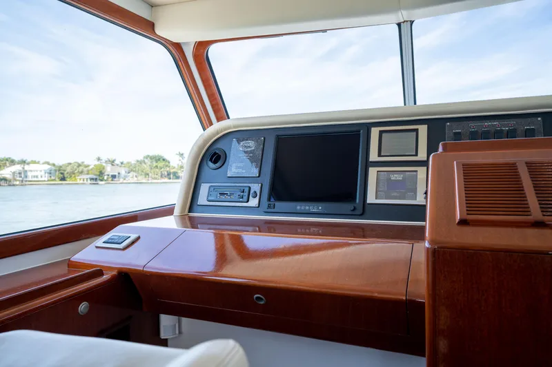 Slide: The Image of Interior helm of 2008 Huckins Linwood yacht with navigation equipment and scenic water view. - 14