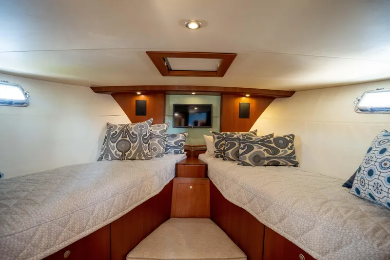 Slide: The Image of Interior cabin of 2008 Huckins Linwood yacht with twin beds and decorative pillows. - 37