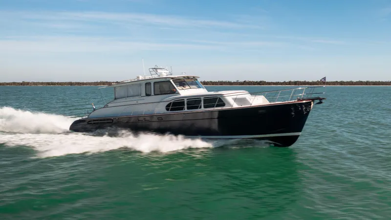 Slide: The Image of 2008 Huckins Linwood yacht cruising on open water. - 4
