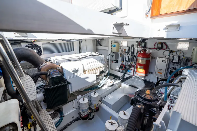 Slide: The Image of Engine room of a 2008 Huckins Linwood yacht with visible machinery and fire extinguisher. - 41