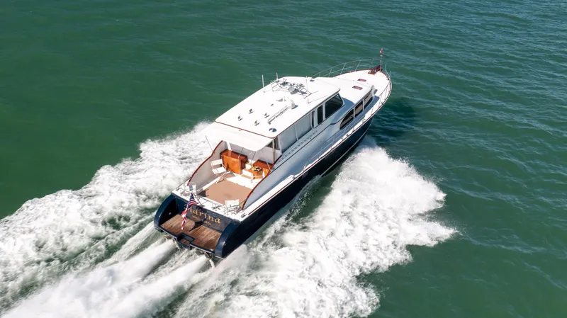 Slide: The Image of 2008 Huckins Linwood yacht cruising on open water. - 5