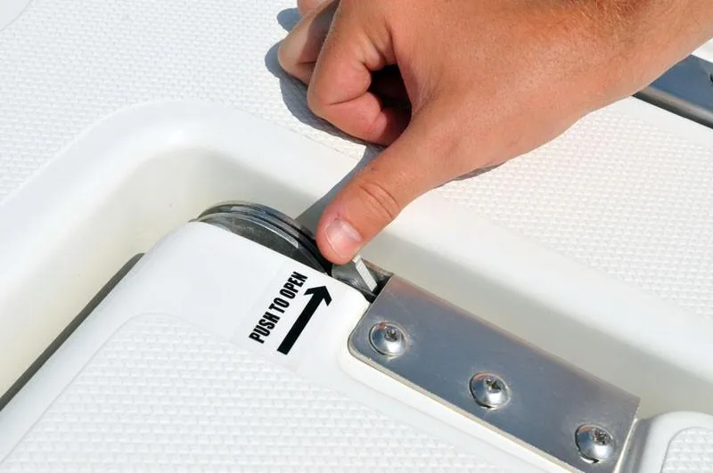 Slide: The Image of Hand operating latch on 2023 NauticStar 215 Bay boat. - 10