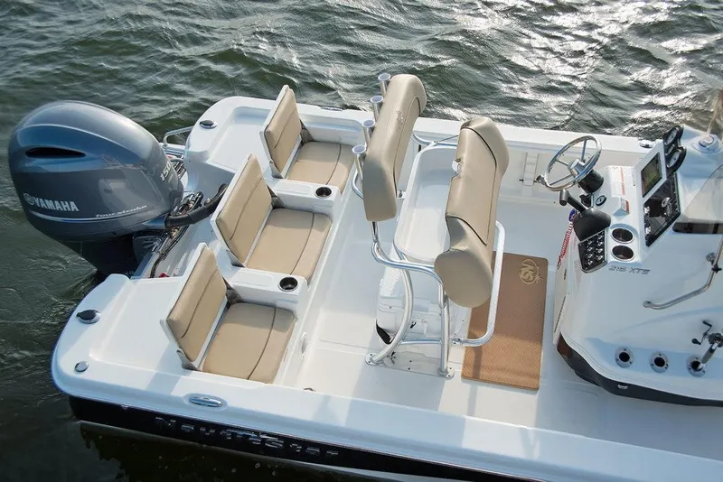 Slide: The Image of 2023 NauticStar 215 Bay boat with Yamaha engine, beige seating, and modern console. - 12