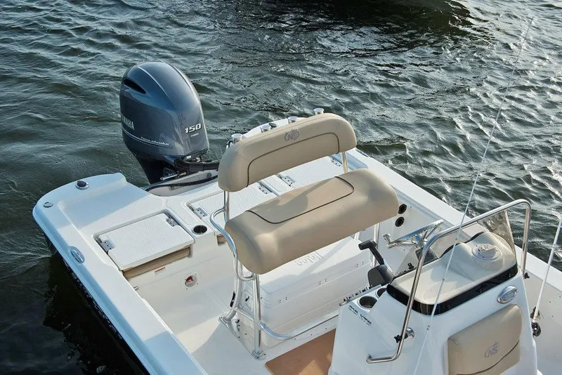 Slide: The Image of 2023 NauticStar 215 Bay boat with Yamaha 150 engine on water. - 13