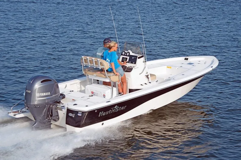 Slide: The Image of 2023 NauticStar 215 Bay boat cruising on water with Yamaha outboard motor. - 4