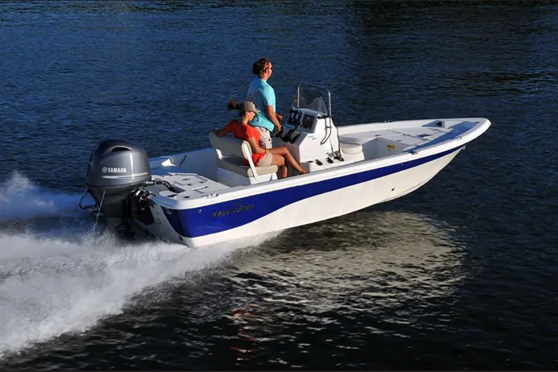 Slide: The Image of 2023 NauticStar 195 Bay boat cruising on water with passengers. - 1