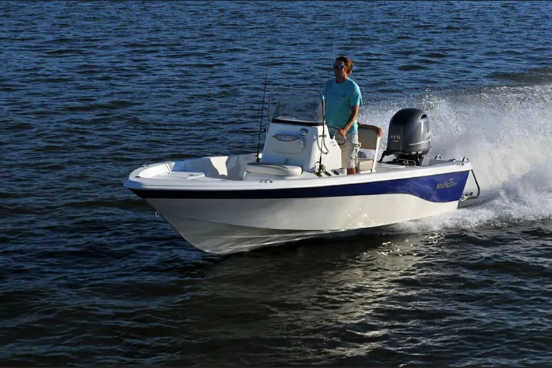 Slide: The Image of 2023 NauticStar 195 Bay boat cruising on open water. - 2