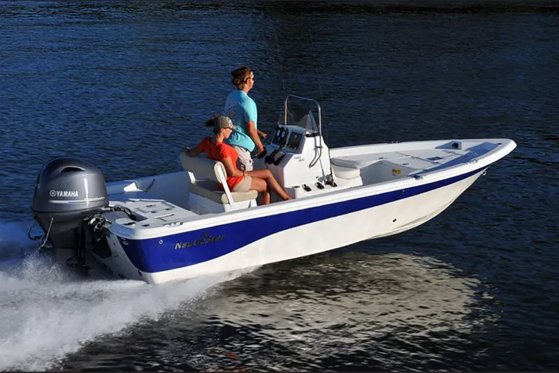 Slide: The Image of 2023 NauticStar 195 Bay boat cruising on water with two passengers. - 3