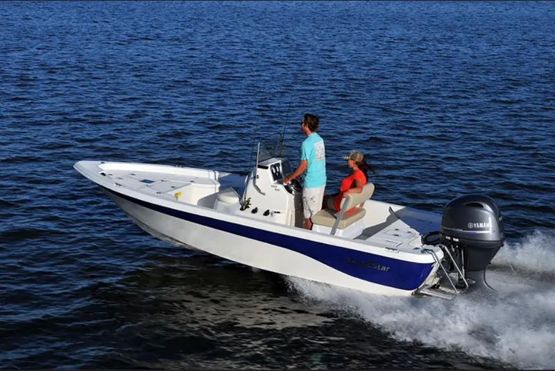 Slide: The Image of 2023 NauticStar 195 Bay boat cruising on open water. - 5