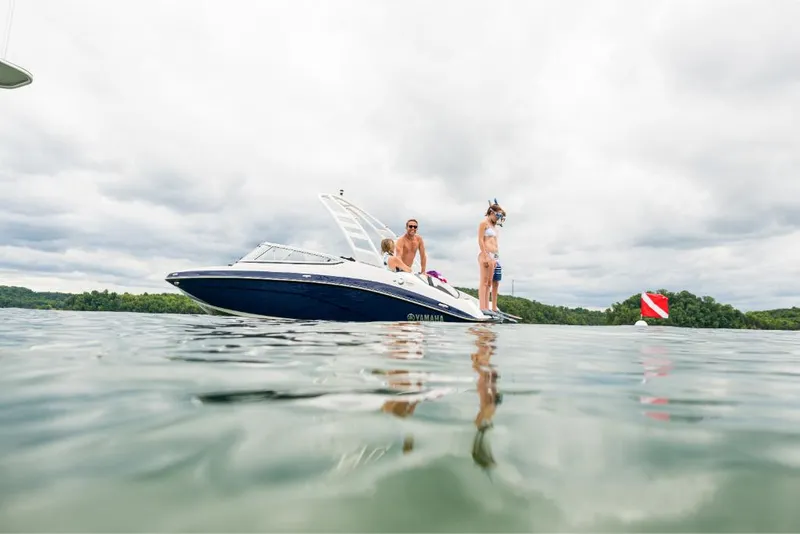 Slide: The Image of 2023 Yamaha Outboards 195S boat on a lake with two people onboard. - 13