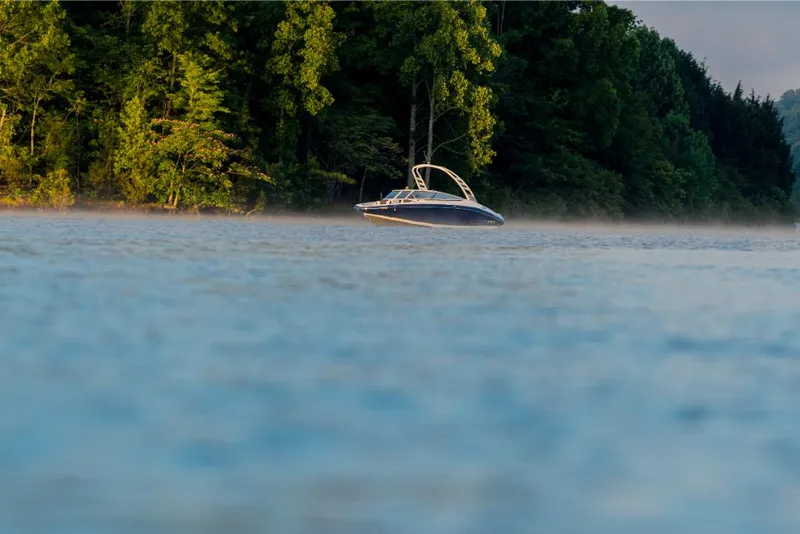 Slide: The Image of 2023 Yamaha Outboards 195S boat on a serene lake near a forest. - 14
