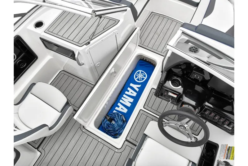 Slide: The Image of 2023 Yamaha Outboards 195S boat interior with storage compartment open. - 18