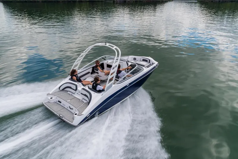 Slide: The Image of 2023 Yamaha Outboards 195S boat cruising on a lake with passengers. - 2